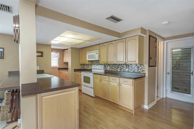 kitchen featuring visible vents, light wood-style floors, light brown cabinetry, and white appliances