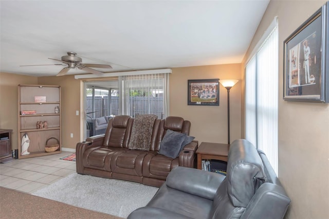 living room with baseboards, ceiling fan, and tile patterned floors