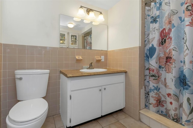 bathroom featuring tile walls, tile patterned flooring, toilet, and curtained shower