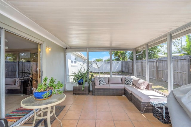 sunroom featuring plenty of natural light and an outdoor living space