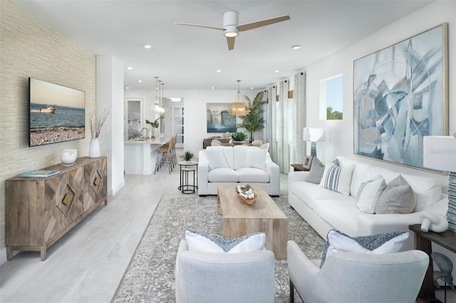 living area with recessed lighting and ceiling fan with notable chandelier