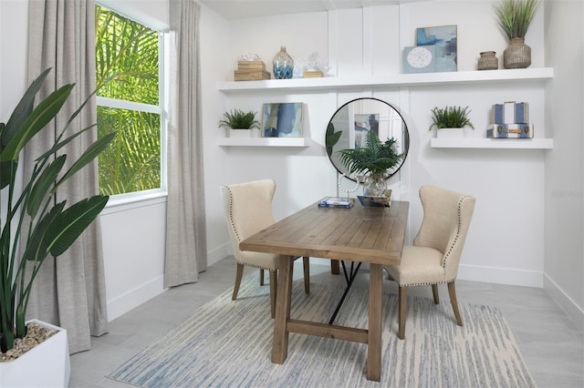 dining space featuring baseboards