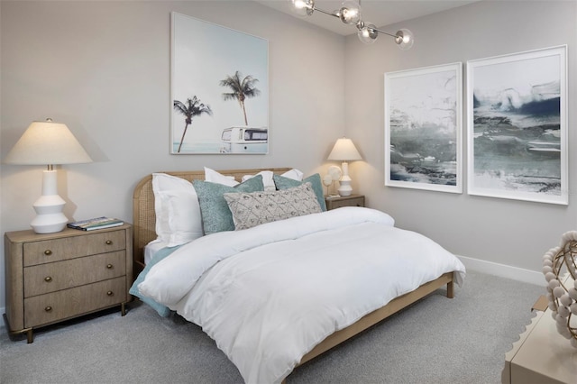 bedroom featuring carpet floors, baseboards, and a chandelier