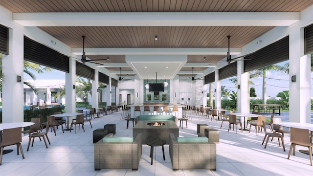 view of patio / terrace featuring outdoor dining area, a ceiling fan, and an outdoor fire pit