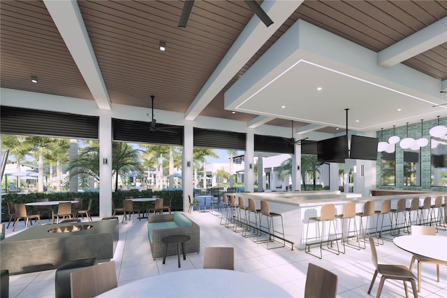 exterior space with a patio, a bar, a ceiling fan, and a fire pit