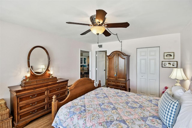 bedroom featuring light wood finished floors, a closet, a ceiling fan, and visible vents