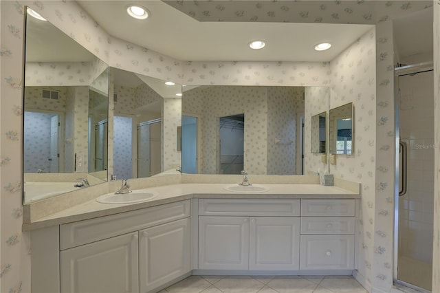 full bathroom featuring visible vents, a sink, a stall shower, and wallpapered walls