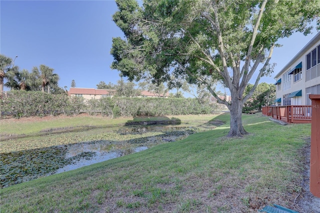 view of yard featuring a deck with water view