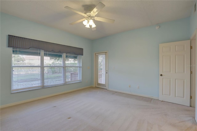 6330 99th Way N Unit 14F, Saint Petersburg, FL 33708 - empty room featuring light colored carpet, a ceiling fan, and baseboards