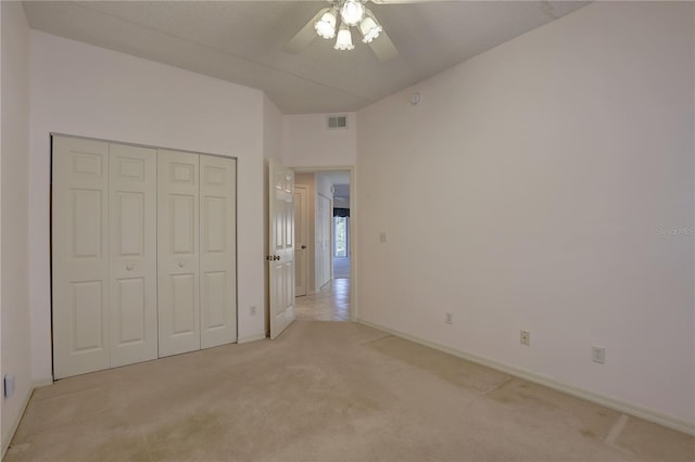 6330 99th Way N Unit 14F, Saint Petersburg, FL 33708 - unfurnished bedroom featuring light colored carpet, baseboards, a closet, and ceiling fan