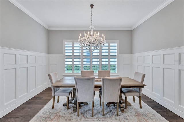 dining space with a chandelier, a wainscoted wall, dark wood-type flooring, and a decorative wall