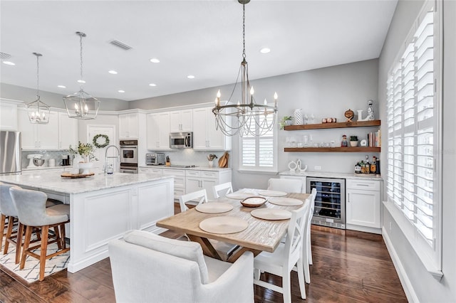 dining space with recessed lighting, an inviting chandelier, and wine cooler