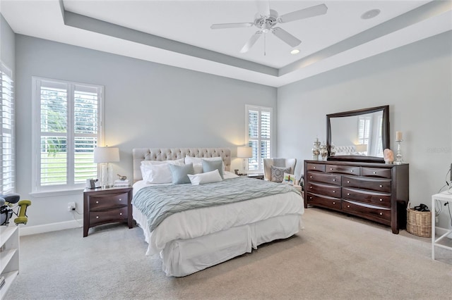 bedroom featuring ceiling fan, a raised ceiling, carpet, recessed lighting, and baseboards