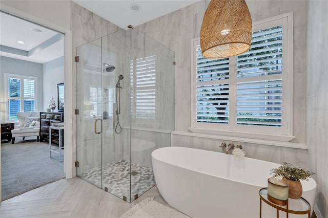 full bath with a freestanding tub and a shower stall