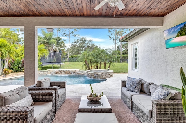 view of pool featuring an outdoor living space, a ceiling fan, a patio area, a trampoline, and a yard