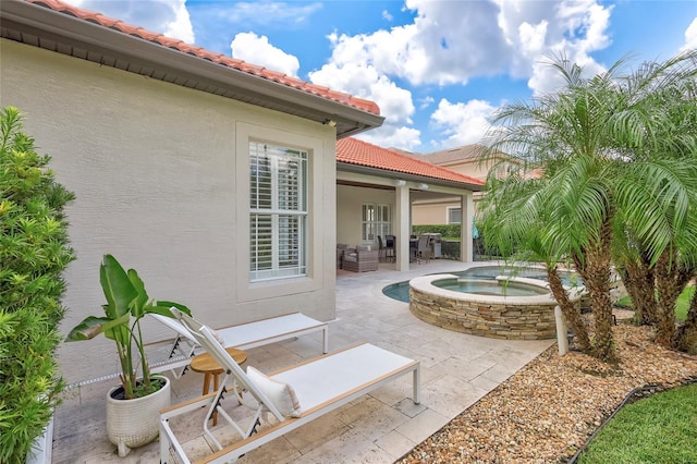 view of patio featuring an in ground hot tub and an outdoor hangout area