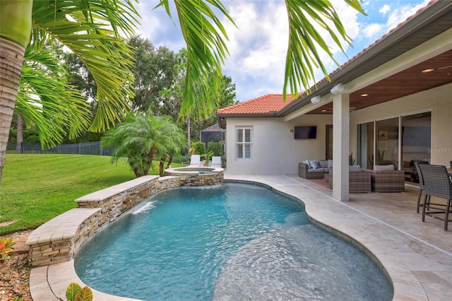 view of pool featuring a lawn, a pool with connected hot tub, fence, an outdoor hangout area, and a patio