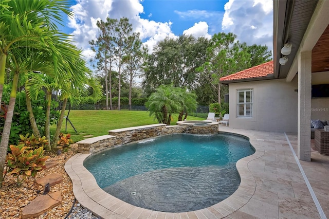 view of pool featuring a patio area, a pool with connected hot tub, a yard, and fence