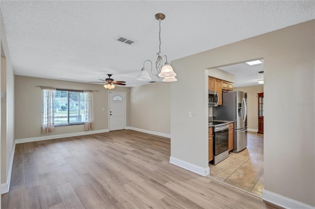 2961 Briar Cliff Dr, Palm Harbor, FL 34684 - interior space with baseboards, light wood finished floors, a textured ceiling, and visible vents