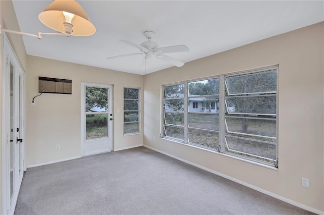 2961 Briar Cliff Dr, Palm Harbor, FL 34684 - empty room with baseboards, plenty of natural light, a wall mounted AC, and carpet floors