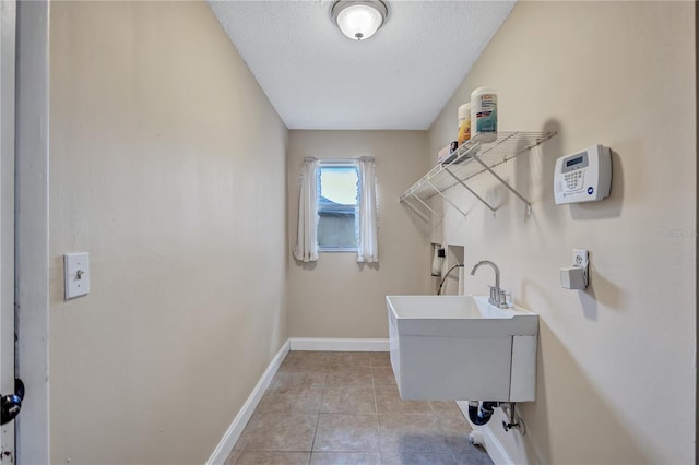 2961 Briar Cliff Dr, Palm Harbor, FL 34684 - clothes washing area with laundry area, a textured ceiling, baseboards, hookup for a washing machine, and light tile patterned flooring