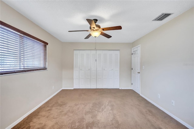 2961 Briar Cliff Dr, Palm Harbor, FL 34684 - unfurnished bedroom with baseboards, carpet, a closet, and visible vents