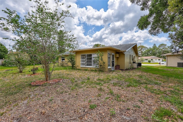 2961 Briar Cliff Dr, Palm Harbor, FL 34684 - exterior space with central air condition unit and stucco siding