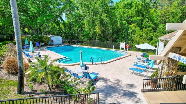 2961 Briar Cliff Dr, Palm Harbor, FL 34684 - community pool featuring fence, an outbuilding, and a patio area