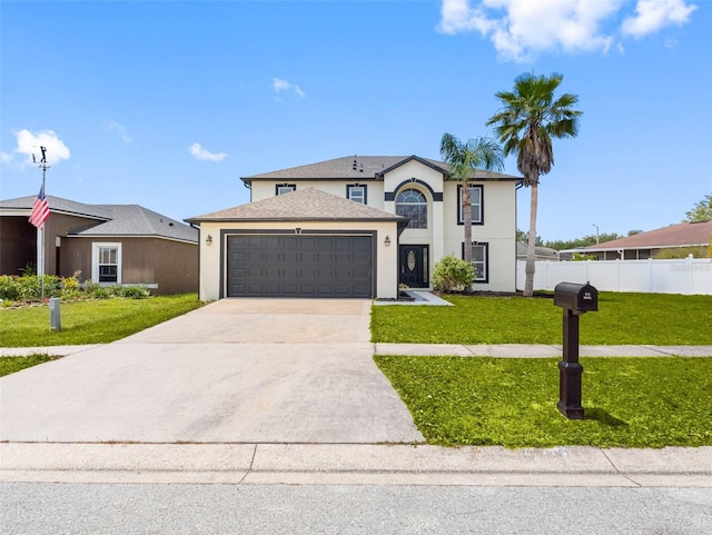 french country inspired facade with a garage, fence, a front lawn, concrete driveway, and stucco siding