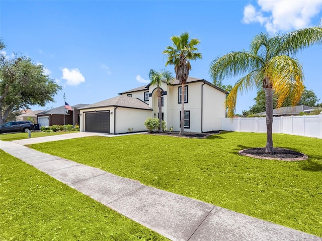 view of front of home with driveway, a garage, fence, a front lawn, and stucco siding