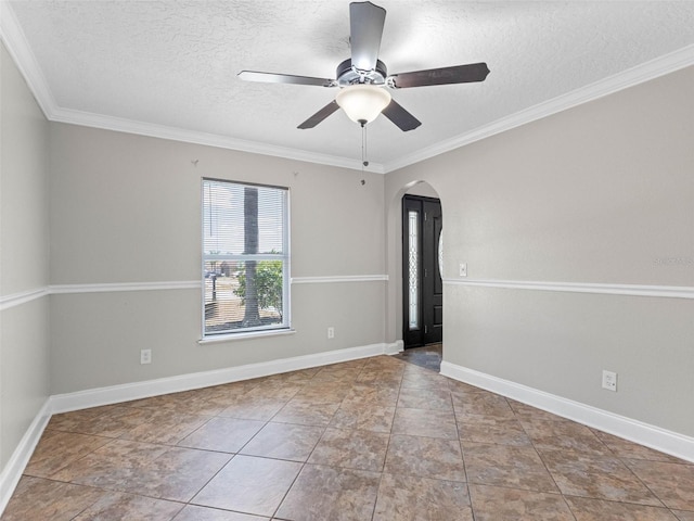 empty room with crown molding, arched walkways, a textured ceiling, and a ceiling fan