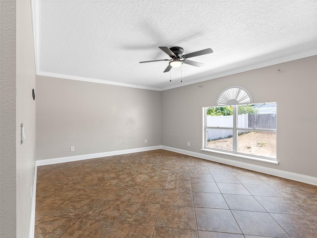 spare room with ceiling fan, tile patterned flooring, a textured ceiling, baseboards, and ornamental molding