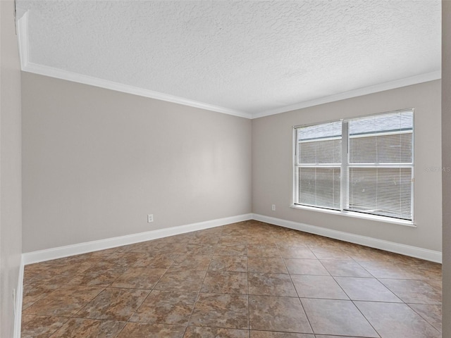empty room with a textured ceiling, ornamental molding, and baseboards
