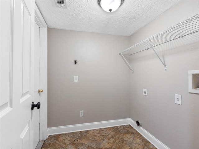 washroom with baseboards, laundry area, electric dryer hookup, and visible vents