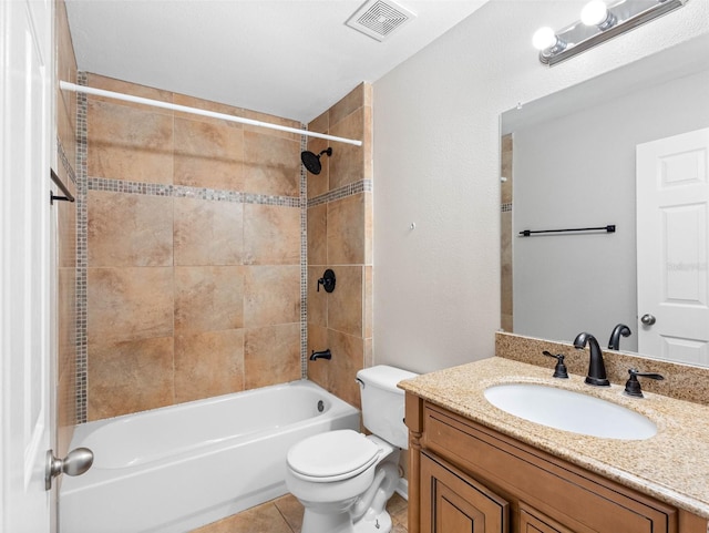 bathroom featuring visible vents, vanity, tile patterned floors, toilet, and bathing tub / shower combination