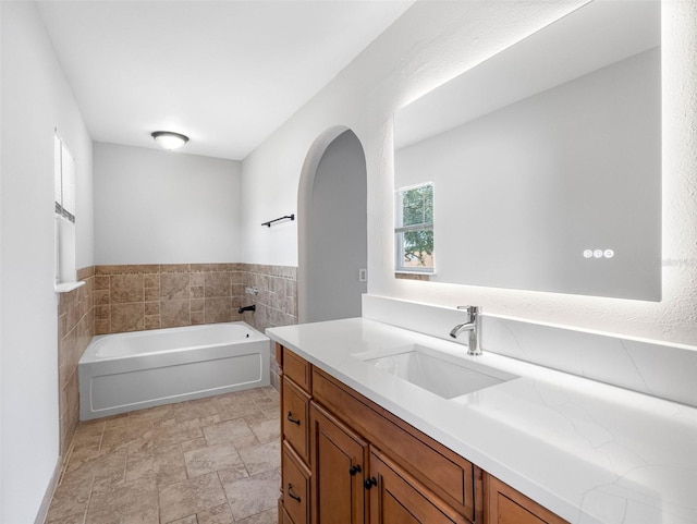 full bath featuring a garden tub and vanity