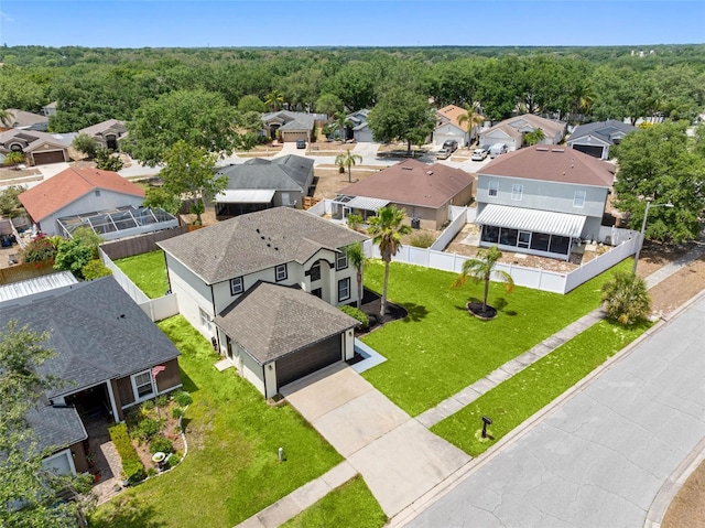 drone / aerial view featuring a forest view and a residential view