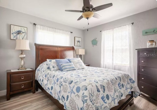 bedroom featuring light wood-style floors and ceiling fan