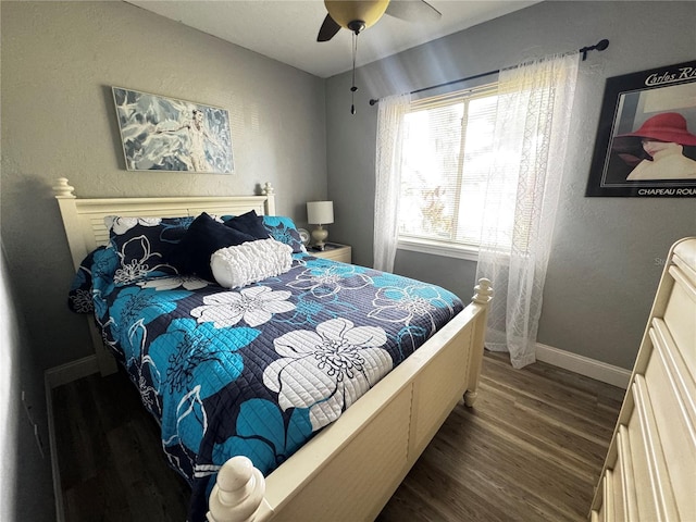 bedroom featuring baseboards, ceiling fan, and wood finished floors