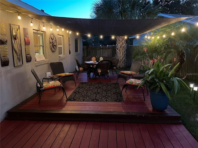 wooden terrace with fence and outdoor dining area