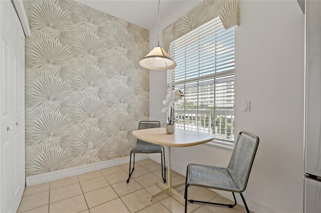 7 Island Park Pl Unit 204, Dunedin, FL 34698 - tiled dining space with baseboards and wallpapered walls