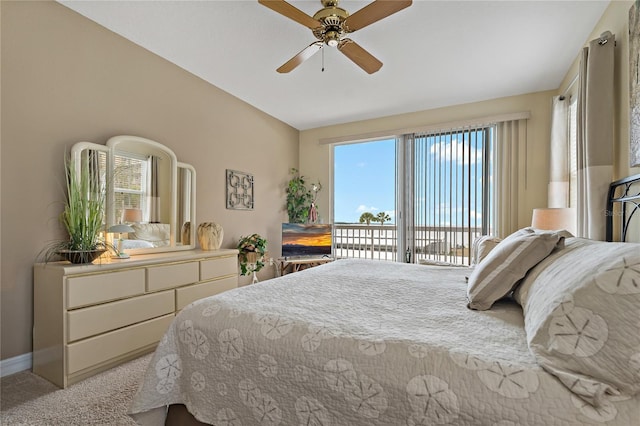 7 Island Park Pl Unit 204, Dunedin, FL 34698 - bedroom featuring access to exterior, carpet floors, baseboards, ceiling fan, and lofted ceiling
