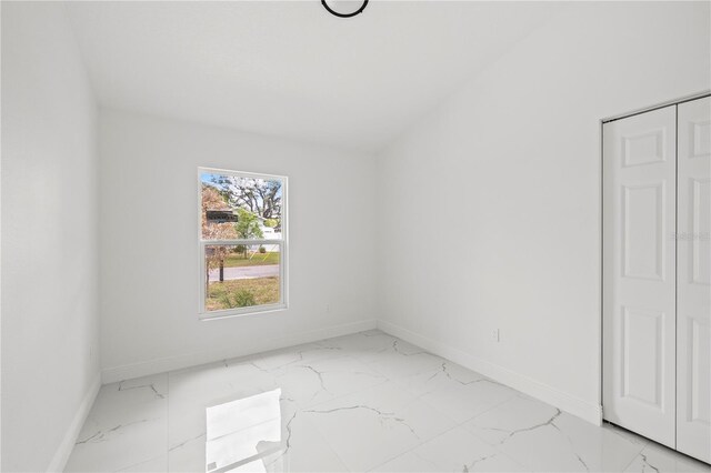 3803 E Curtis St, Tampa, FL 33610 - empty room with light marble finish flooring and baseboards
