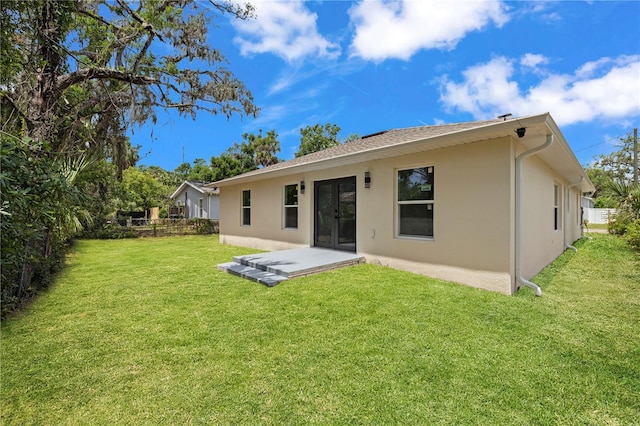 3803 E Curtis St, Tampa, FL 33610 - rear view of house with stucco siding and a patio area