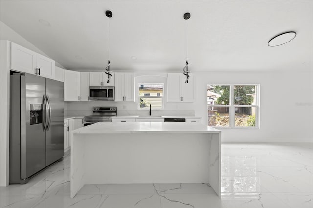 3803 E Curtis St, Tampa, FL 33610 - kitchen featuring stainless steel appliances, light marble finish flooring, a sink, a center island, and white cabinetry