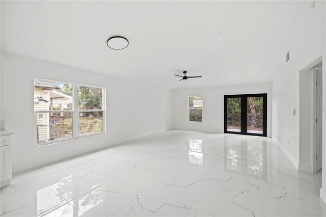 3803 E Curtis St, Tampa, FL 33610 - empty room featuring light marble finish flooring, baseboards, and ceiling fan