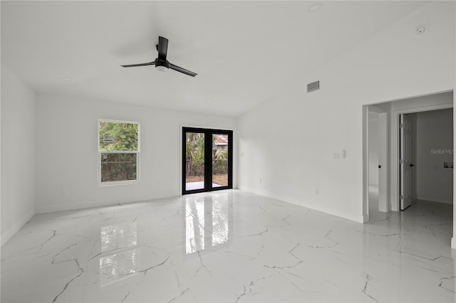 3803 E Curtis St, Tampa, FL 33610 - spare room with marble finish flooring, a ceiling fan, baseboards, lofted ceiling, and french doors