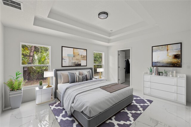 3803 E Curtis St, Tampa, FL 33610 - bedroom with a tray ceiling, light marble finish floors, a spacious closet, and baseboards