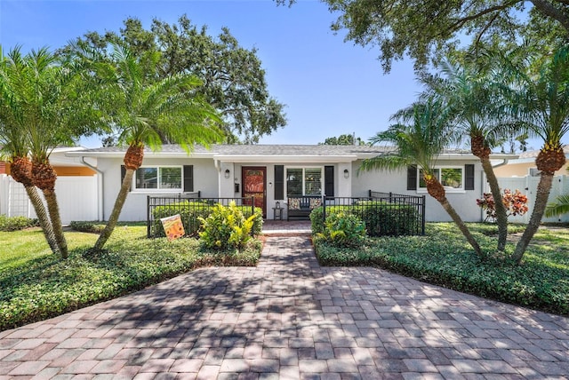 ranch-style home with fence private yard, stucco siding, and a porch