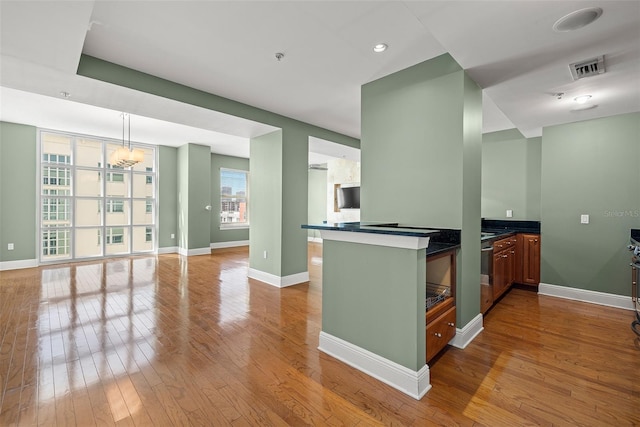 1227 E Madison St Unit 902, Tampa, FL 33602 - kitchen featuring hardwood / wood-style flooring, dark countertops, baseboards, open floor plan, and recessed lighting
